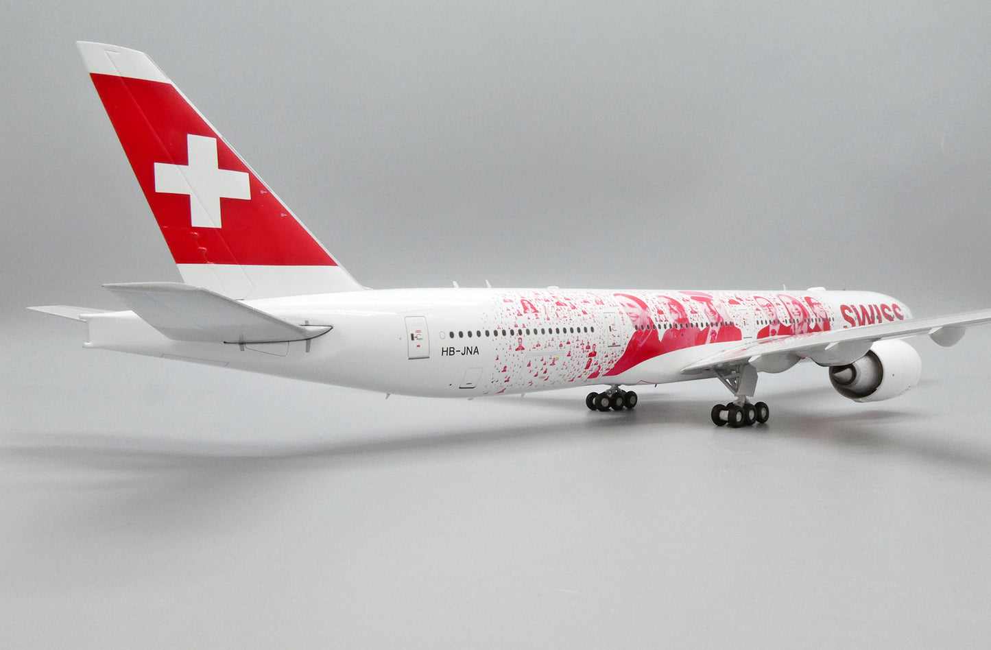 JC WINGS B777-300ER SWISS "FACES OF SWISS" REG: HB-JNA